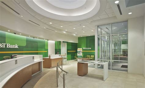 the inside of a bank with green and yellow accents on the walls, glass ...