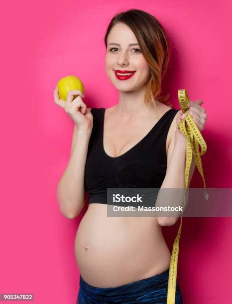 Female In Fitness Clothes With Tape Measure And Apple Stock Photo - Download Image Now - iStock