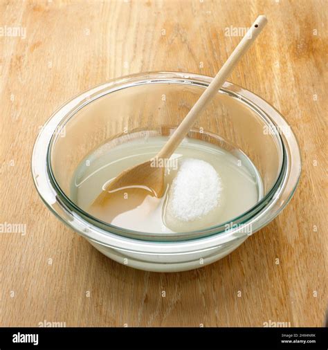 Sugar dissolving in a bowl of water Stock Photo - Alamy