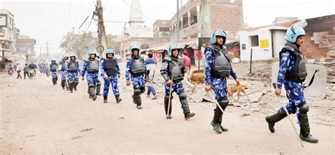 Members of Rapid Action Force patrol a road in a riot affected area in ...