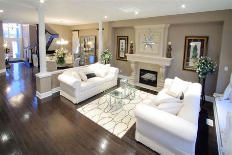 Dark flooring contrast nicely with the beige pallet and white furniture in this Classics of ...