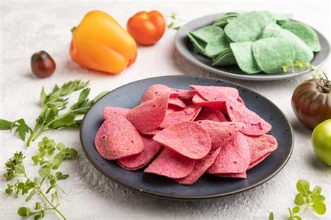 Premium Photo | Green and red potato chips on gray concrete background ...