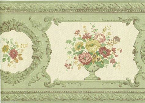 an ornate green frame with flowers painted on the wall and in between two smaller frames