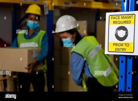 Caution sign in factory warning to industry labor worker to prevent Covid-19 Stock Photo - Alamy