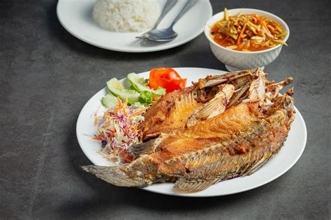 Fried snapper in a plate placed on a black background 3096158 Stock Photo at Vecteezy