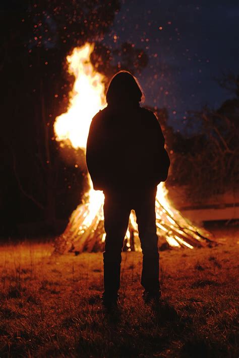HD wallpaper: silhouette of person standing in front of bonfire, flame, dark | Wallpaper Flare