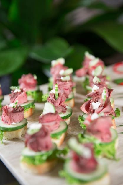 Free Photo | Delicious mini canapes with meat on buffet table