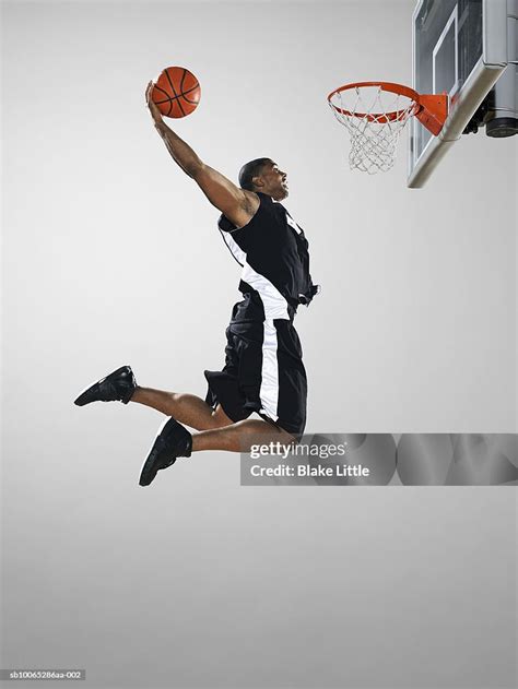 Basketball Player Dunking Ball Low Angle View High-Res Stock Photo ...