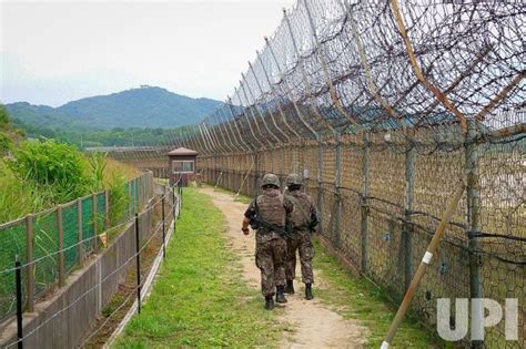 Photo: Soldiers walk beside a fence in the DMZ Peace Trail. - GOS2019061405 - UPI.com