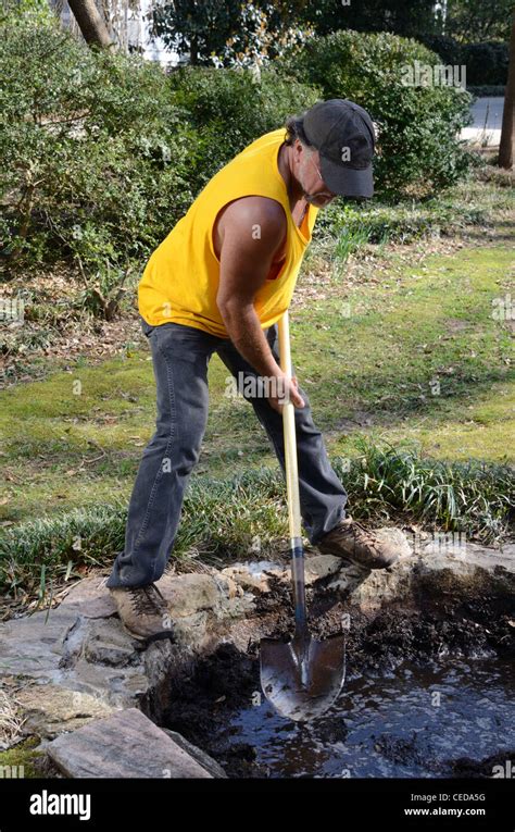 landscaper digging a pond Stock Photo - Alamy