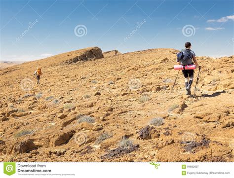 Three Backpackers Walking Ascending Mountain Rock Desert Slope. Stock Image - Image of mountains ...