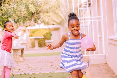 Happy little black children having fun in yard with balloons · Free ...