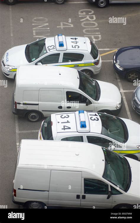 Police cars & vans parked in a West Yorkshire police station compound ...