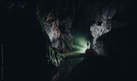 Entrance in dark cave with man speleologist exploring | Nature ...