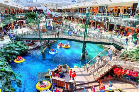 the inside of a mall filled with water slides and people on rafts in it