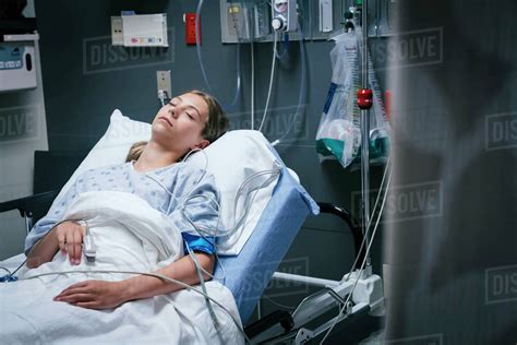 Caucasian girl sleeping in hospital bed - Stock Photo - Dissolve