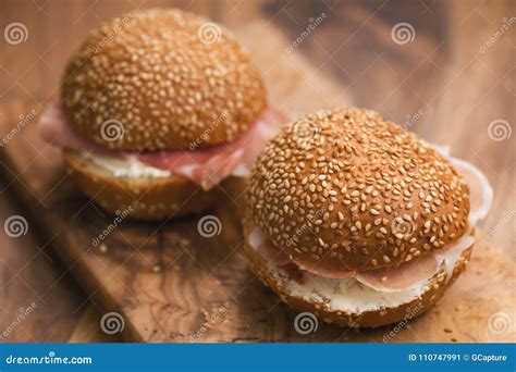 Prosciutto and Cream Cheese in a Sesame Buns on Wood Board Stock Image - Image of organic, crudo ...