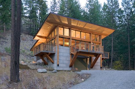 A 1,600 square foot cabin built into a steep hillside overlooking a stream with a view to the ...