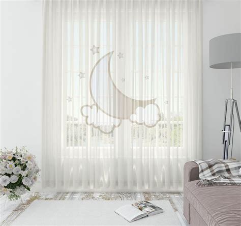 a living room with white curtains and flowers on the floor