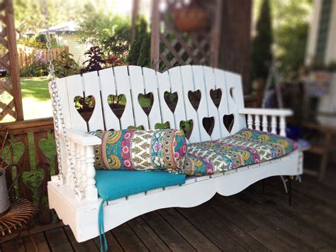 a white wooden bench with pillows on it