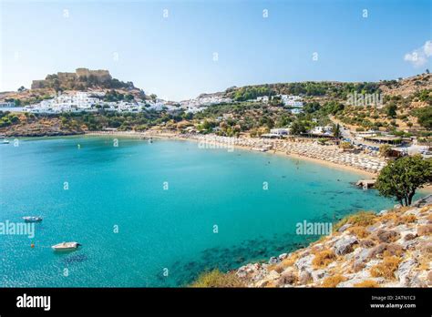 Lindos beach and white houses of village of Lindos and Acropolis in background (Rhodes, Greece ...