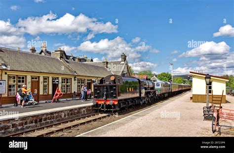 Strathspey Steam Railway Scotland early summer the steam train LMS 5025 arriving at Boat of ...