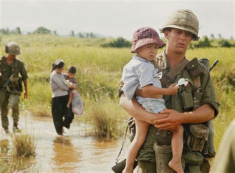 Vietnam War 1966 | An American soldier carries a Vietnamese … | Flickr