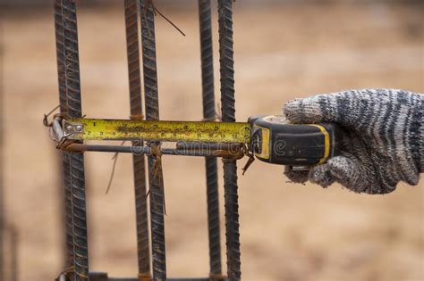 Measuring Steel Rod at Construction Site with Tape Measure Stock Image ...