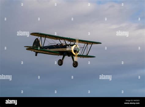 Airplane vintage bi-plane aircraft flying at air show Stock Photo - Alamy