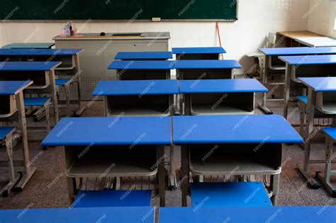 Premium Photo | Empty classroom with chairs desks and chalkboard