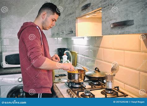 Man Cooking Pasta Spaghetti at Home in the Kitchen. Guy Cooking a Tasty ...