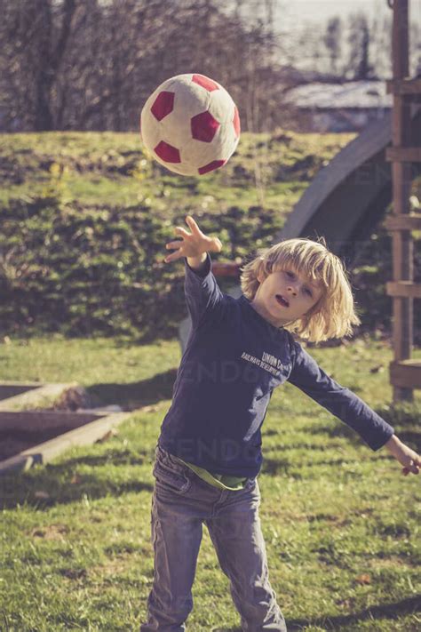 Little boy throwing a ball stock photo