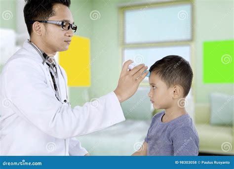 Pediatrician Using a Digital Thermometer for Patient Stock Photo ...