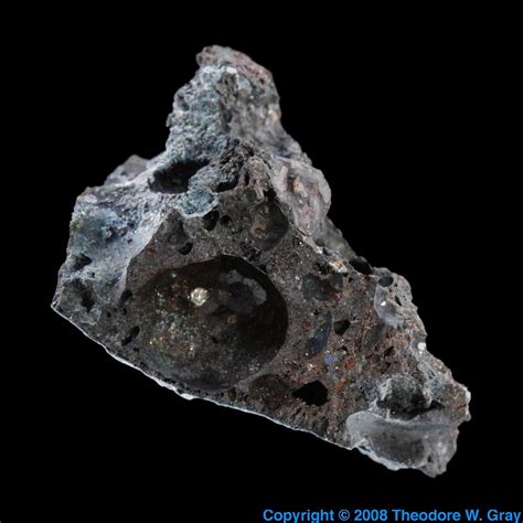 Rough titanium metal in slag, a sample of the element Titanium in the Periodic Table