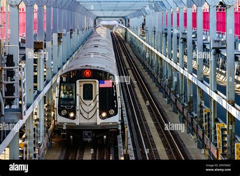 Subway train traveling on tracks across the Williamsburg Bridge from ...