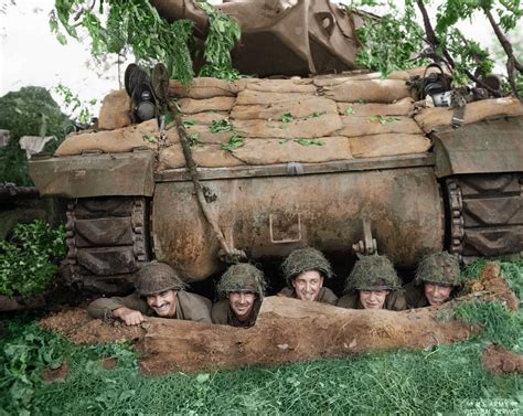 A US tank crew posing for the camera from a foxhole beneath their M-10 tank destroyer, north of ...