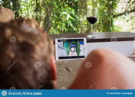 Bali, Indonesia - January, 6, 2022: Man Watching Japanese Cartoon and Drinking Wine in Tropical ...
