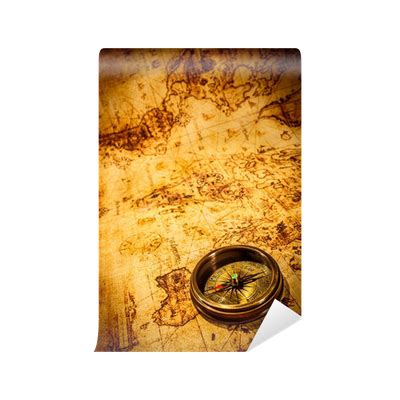 Wall Mural Vintage compass lies on an ancient world map. - PIXERS.UK
