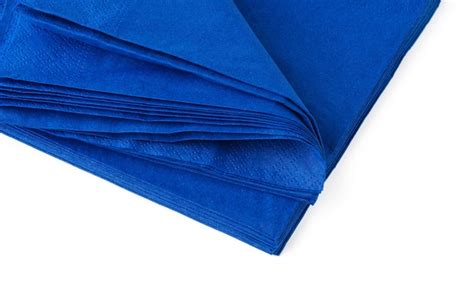 Premium Photo | Stack of blue paper napkins on white background