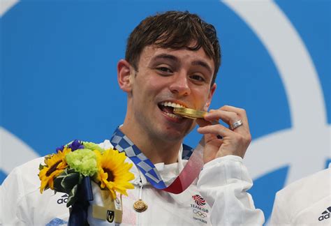 Tom Daley is delivered a bag of yarn during the diving at the Tokyo Olympics