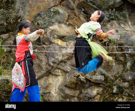 Hani girls playing Chinese jump rope, Yuanyang, Honghe, Yunnan , China Stock Photo - Alamy