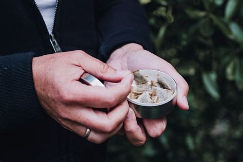 Photo | Man holding smokeless tobacco | UCLA