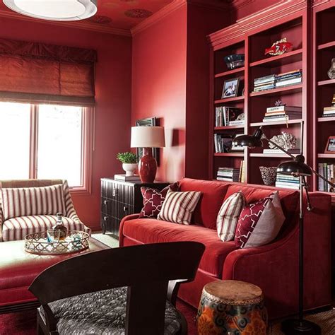 a living room with red walls and furniture