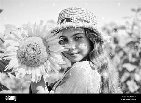 Beautiful face little girl playing sunflowers nature background Stock ...
