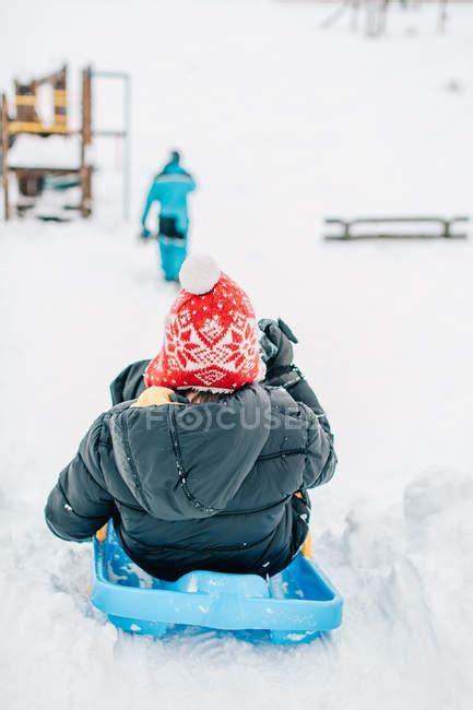 Boy sledding down a hill at winter — snow, leisure activity - Stock ...