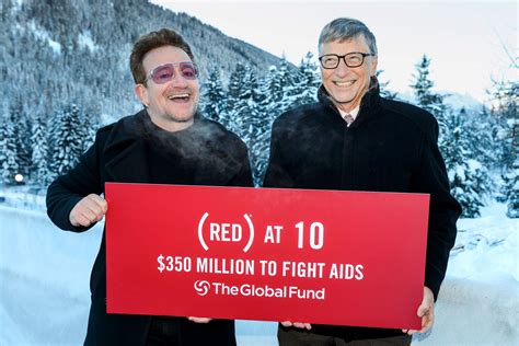 Singer of Irish band U2, Bono (L) poses with Bill Gates at the World ...