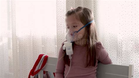 Cute Little Girl in the Mask of an Inhaler. Procedure of Inhalation at Home Stock Footage ...