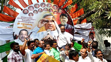 Supporters of Congress leader Siddaramaiah cheer while demanding chief minister post for him