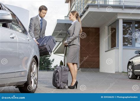 Businesspeople Unloading Luggage from Car Outside Hotel Stock Photo - Image of building ...