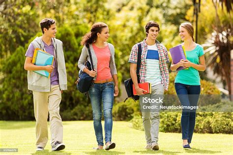 Happy College Students Walking On Campus Stock Photo - Download Image Now - iStock